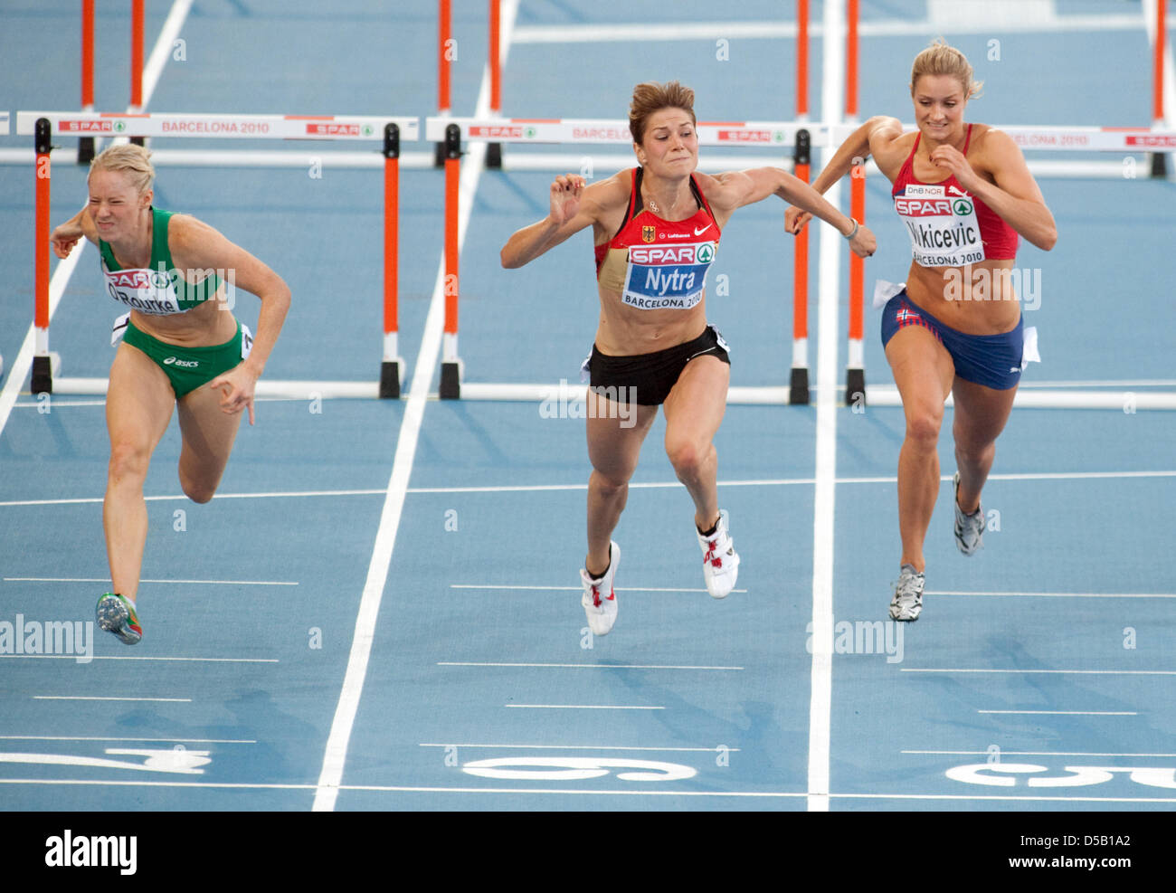 The German hurdler Carolin Nytra (M), Derval O`Rourke (L) from Ireland and Christina Vukicevic from Norway run at the European Athletics Championships at Olympic Stadium Lluis Companys in Barcelona, Spain, 31 July 2010. Photo: Bernd Thissen Stock Photo